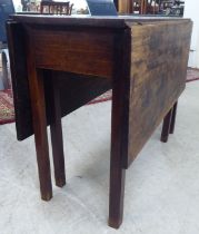 A George III mahogany drop-leaf table, raised on square legs  28"h  39"L extending to  46"L