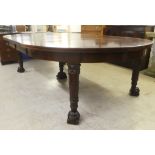 A mid Victorian mahogany, three section dining table with carved ends, raised on carved and turned