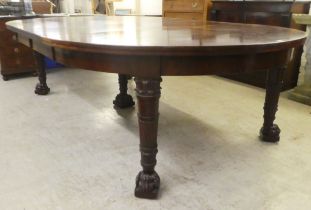 A mid Victorian mahogany, three section dining table with carved ends, raised on carved and turned