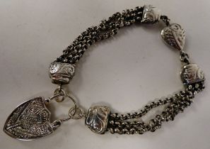 A silver coloured metal triple strand bracelet with an agate set pendant