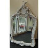 A late 19thC porcelain mirror, surmounted by cherubic figures  28" x 18"