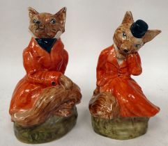 Two Staffordshire china models, foxes wearing hunting jackets  8" & 9"h