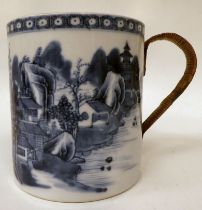 A late 18thC Chinese porcelain mug, decorated with a landscape  5"dia