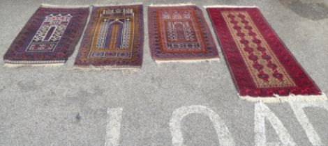 Four dissimilar rugs: to include a Turkoman, on a red ground  34" x 75"