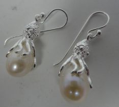 A pair of white metal and river pearl set pendant earrings