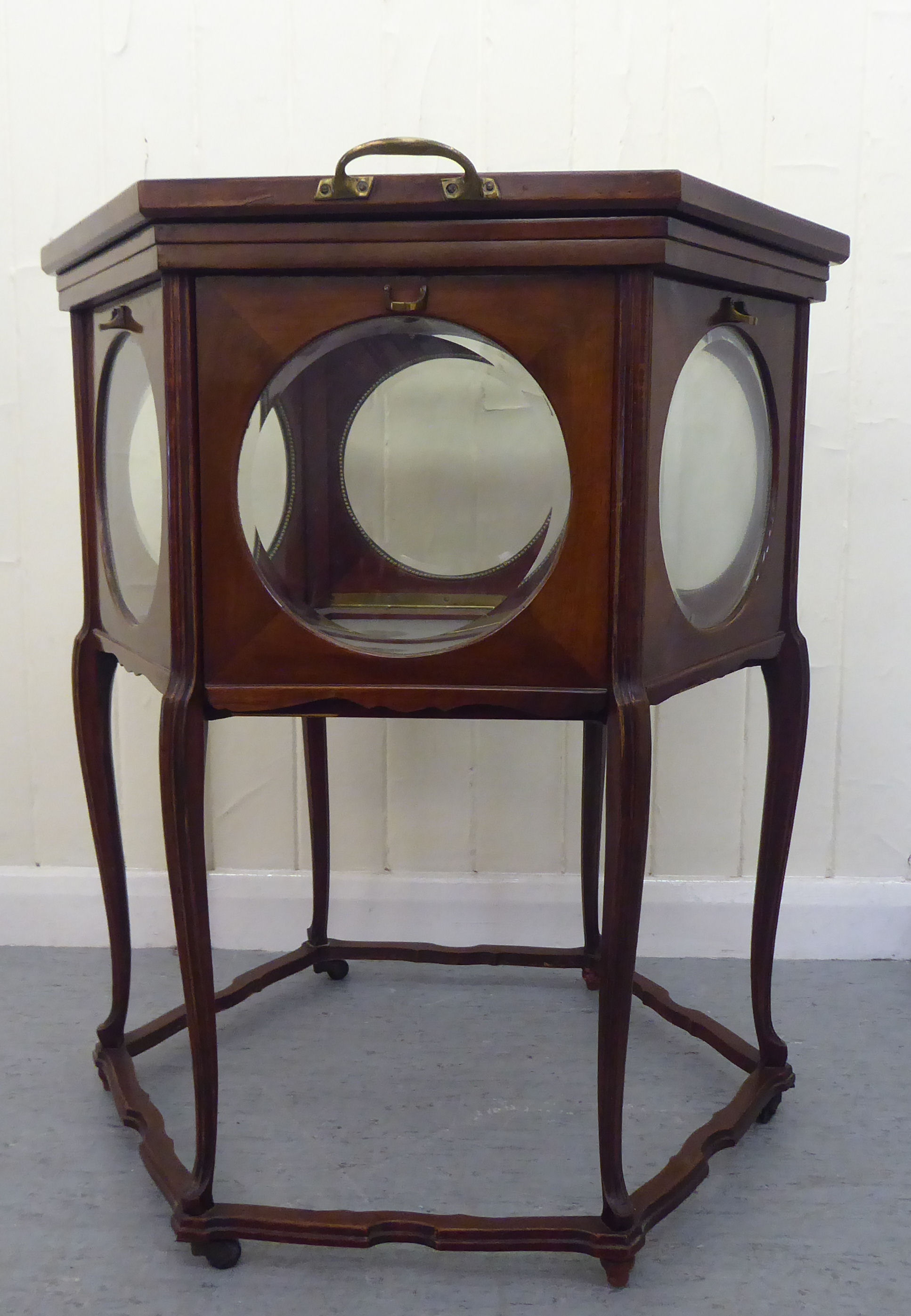 A 20thC mahogany framed and glazed panelled serving tray with a removable tray top and six hinged