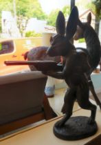 A cast bronze model, a hunting hare holding a double barrel shotgun  36"h overall