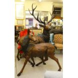 A modern cast bronze model, a one piece stag  94"h; and a doe  54"h both with provision in the