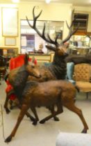 A modern cast bronze model, a one piece stag  94"h; and a doe  54"h both with provision in the