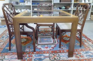 A modern mahogany dining table with an inset glass top, raised on square legs  30"h  39"sq; and a