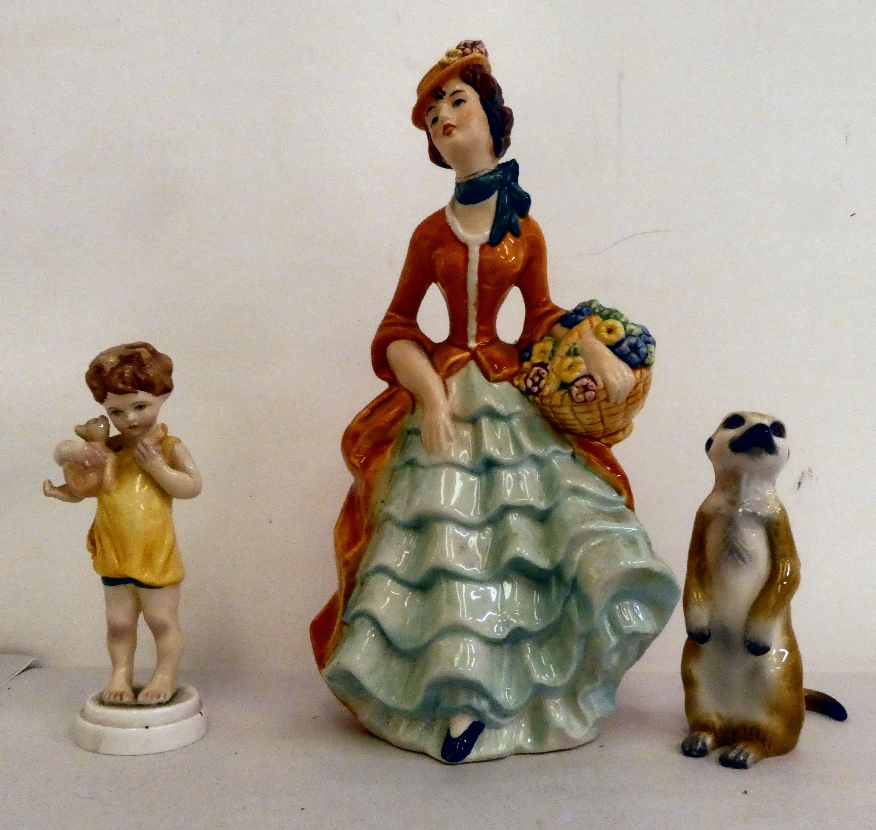 Ceramic ornaments: to include a Goebel china female figure  8"h; a Royal Worcester porcelain 'Poor