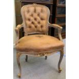 A modern French carved giltwood framed salon chair with open arms, part button upholstered in pale