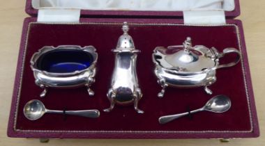 A three piece silver condiments set  comprising a pepper pot, salt and mustard pot  Sheffield