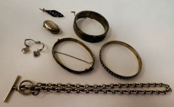 Silver and white metal items of personal ornament: to include a hinged bangle with engraved ornament
