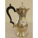 A Queen Anne design silver hot water pot with an ebonised handle  Birmingham 1929  9"h