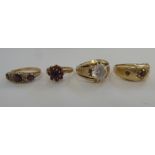 Four variously set 9ct and gold coloured metal rings