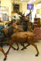 A modern cast bronze model, a one piece stag  94"h; and a doe  54"h both with provision in the