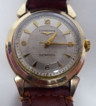 A Longines automatic wristwatch, the 10k gold fitted case, faced by an Arabic and dagger dial, on