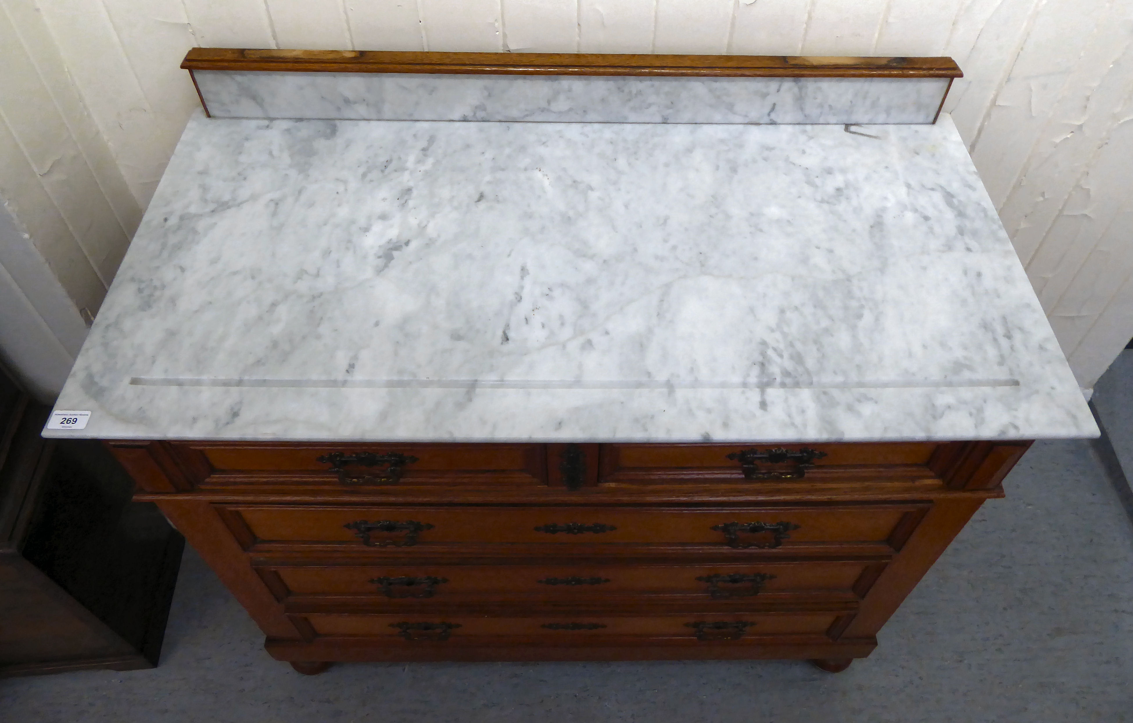 An early/mid 20thC oak commode, the fixed grey/white marble top, over two short/three long - Image 2 of 6