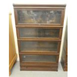 A 1920s/30s oak Globe Wernicke four section bookcase with lift and slide doors and a base drawer, on