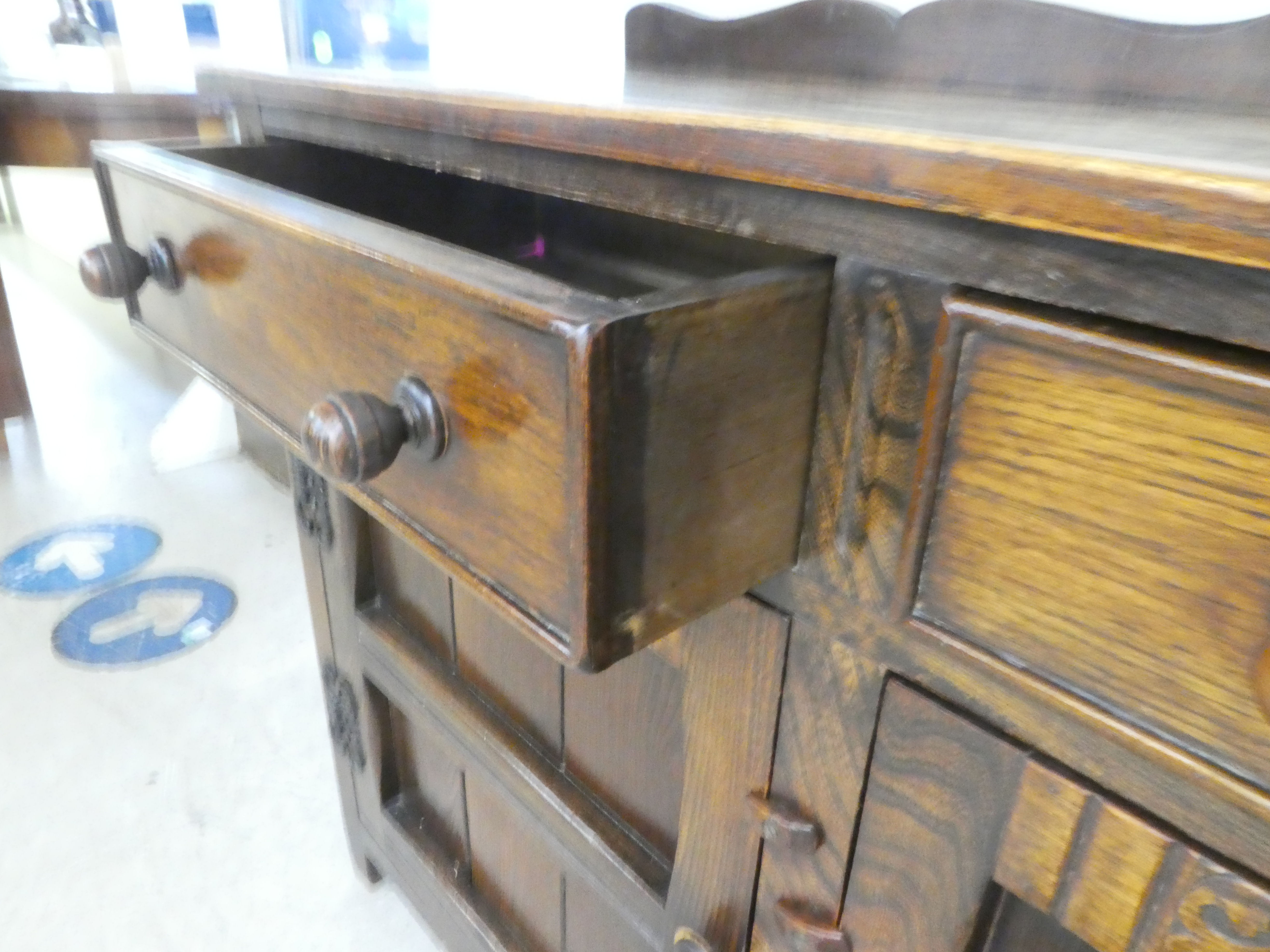 A 20thC Old English style oak dresser with two frieze drawers, over two panelled doors, raised on - Image 4 of 4