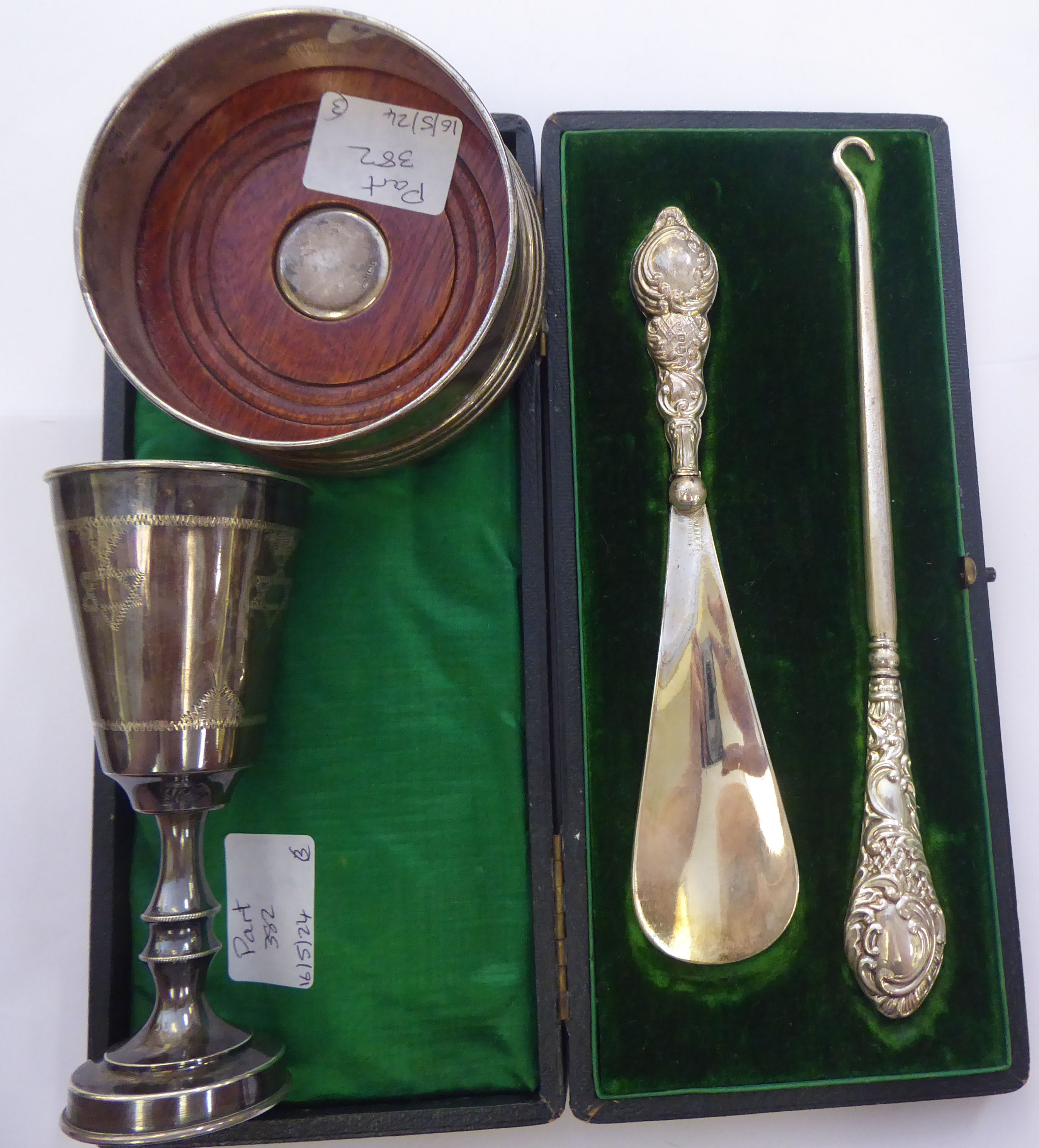 A silver Kiddush cup of tapered form, on a knopped stem; a silver wine coaster, on a turned mahogany