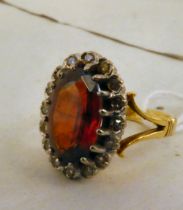 An 18ct gold diamond and garnet cluster ring
