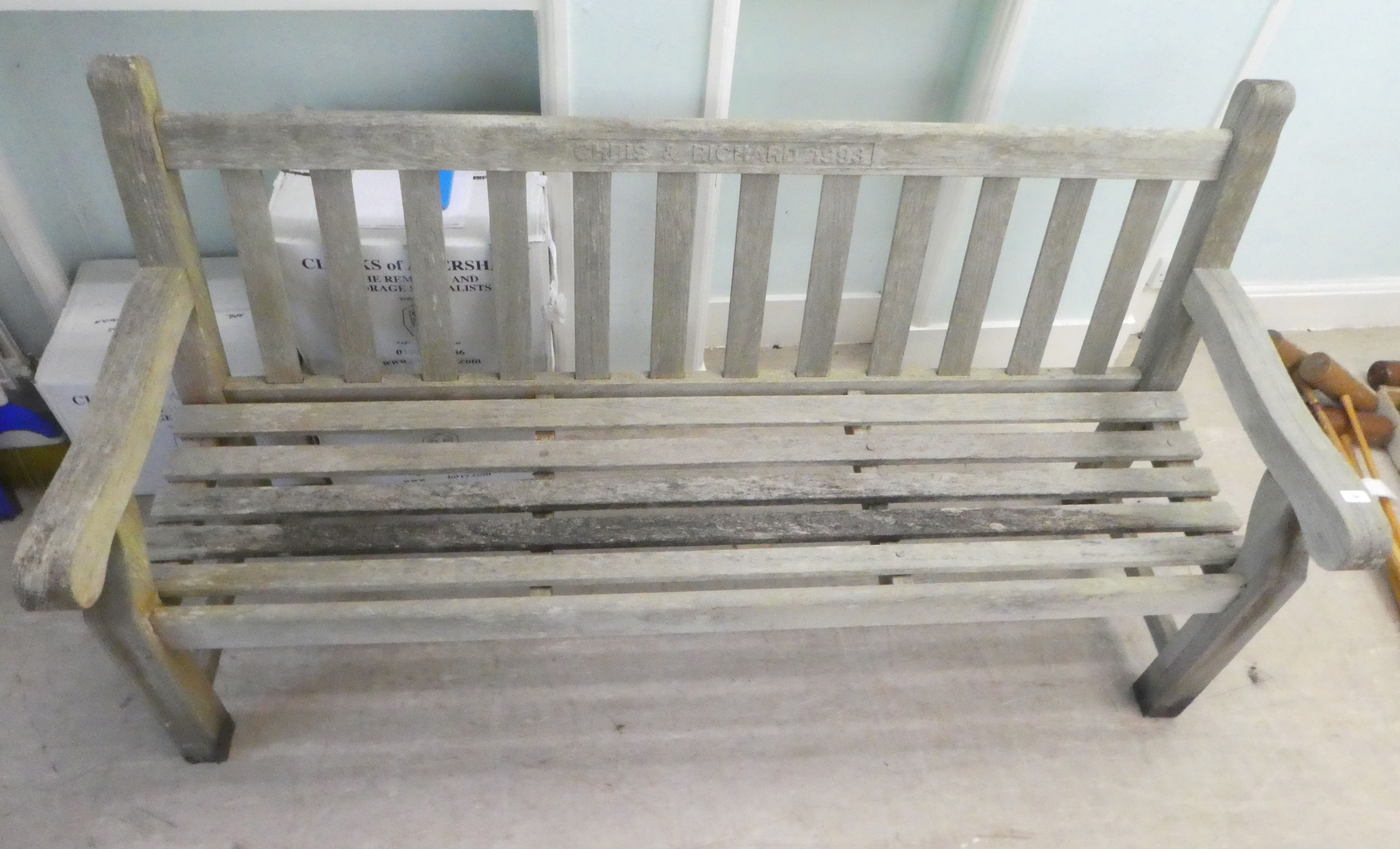 A slatted weathered teak garden bench, raised on square legs  70"w - Image 3 of 4