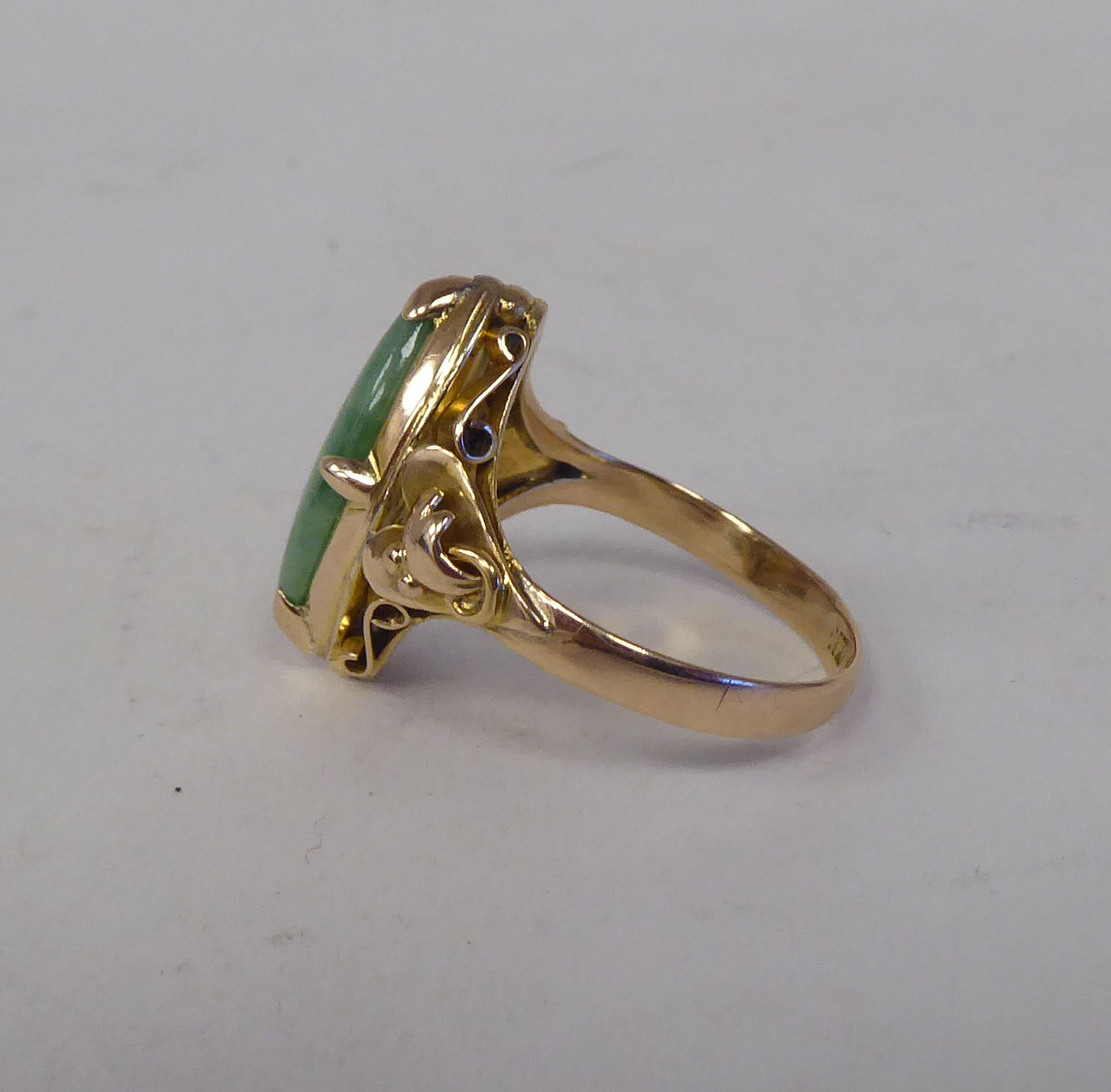 A yellow metal ring, set with a cabochon jade  stamped 14k - Image 2 of 3