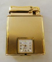 A Colibri Monopol gold plated cigarette lighter, incorporating a miniature timepiece