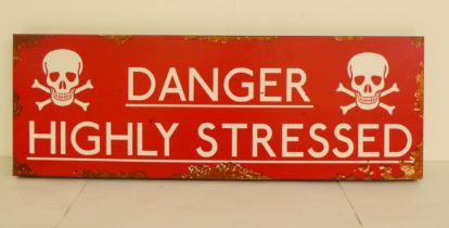 A painted white on red iron sign 'Danger Highly Stressed'  8" x 23"