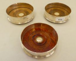 A matched set of three silver coasters with wooden bases  mixed marks  5"dia