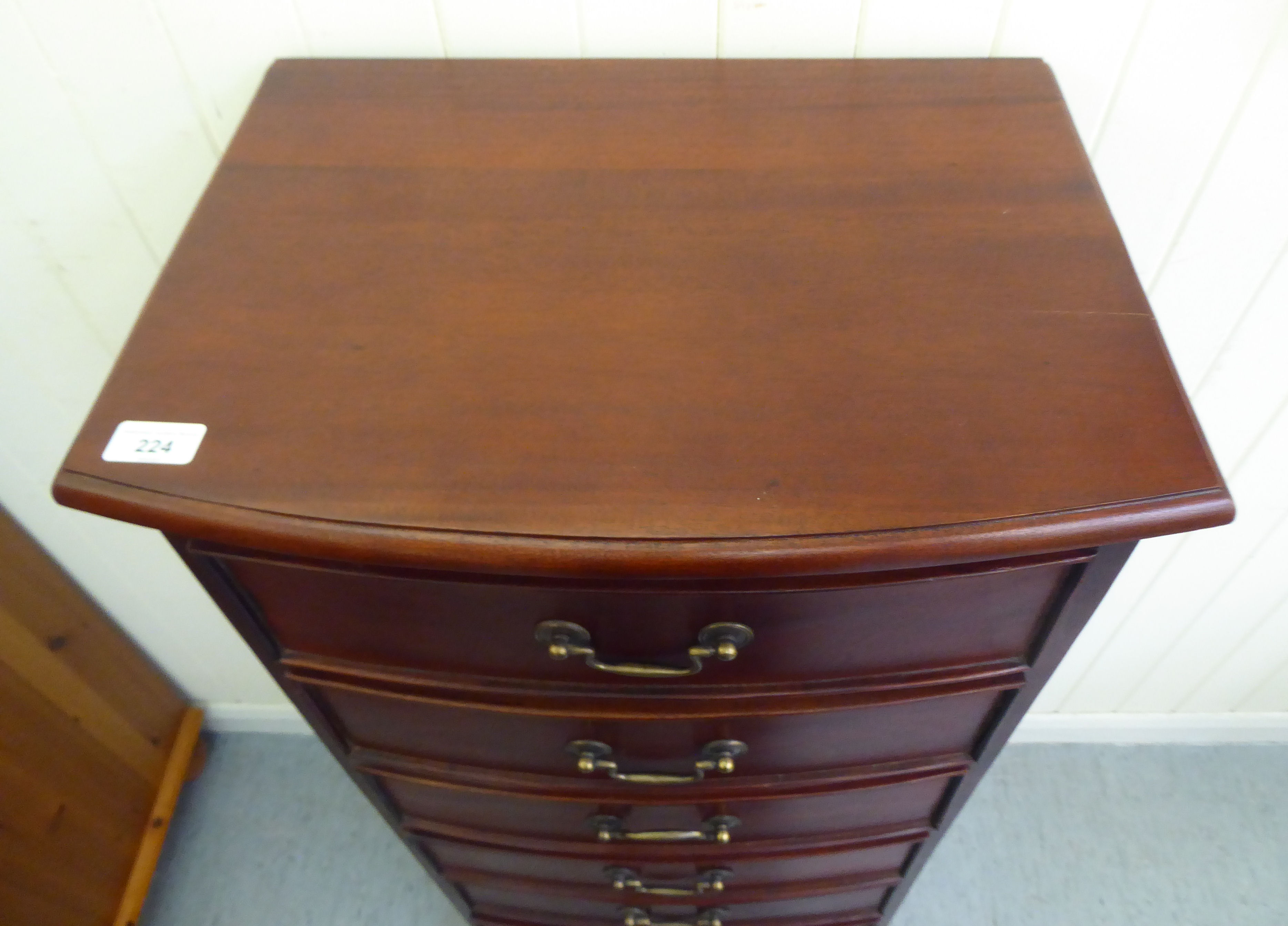 A modern mahogany bow front seven drawer tallboy, raised on bracket feet  47"h  20"w - Image 2 of 4