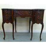 A 20thC Continental inspired mahogany kidney shaped three drawer dressing table, raised on