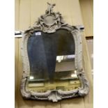 A late 19thC porcelain mirror, surmounted by cherubic figures  28" x 18"