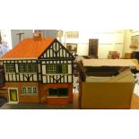 A Tudor design dolls house  23"h  24"w; and various spare interior parts