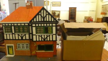 A Tudor design dolls house  23"h  24"w; and various spare interior parts