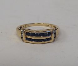 A 9ct gold ring, set with two bands of sapphires, flanked by diamonds