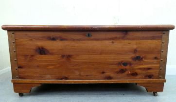 A modern pine chest with straight sides and a hinged lid, raised on bracket feet  16"h  37"w