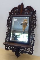 A 1930s oak front carved oak, mirrored and shelved bracket  26"h  14"w