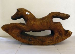 A carved and stained wooden rocking horse  17"h  29"w