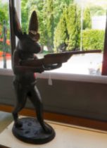 A cast bronze model, a hunting hare holding a double barrel shotgun  36"h overall