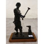 A patinated bronze model  'Ironmonger' on a wooden plinth  14"h
