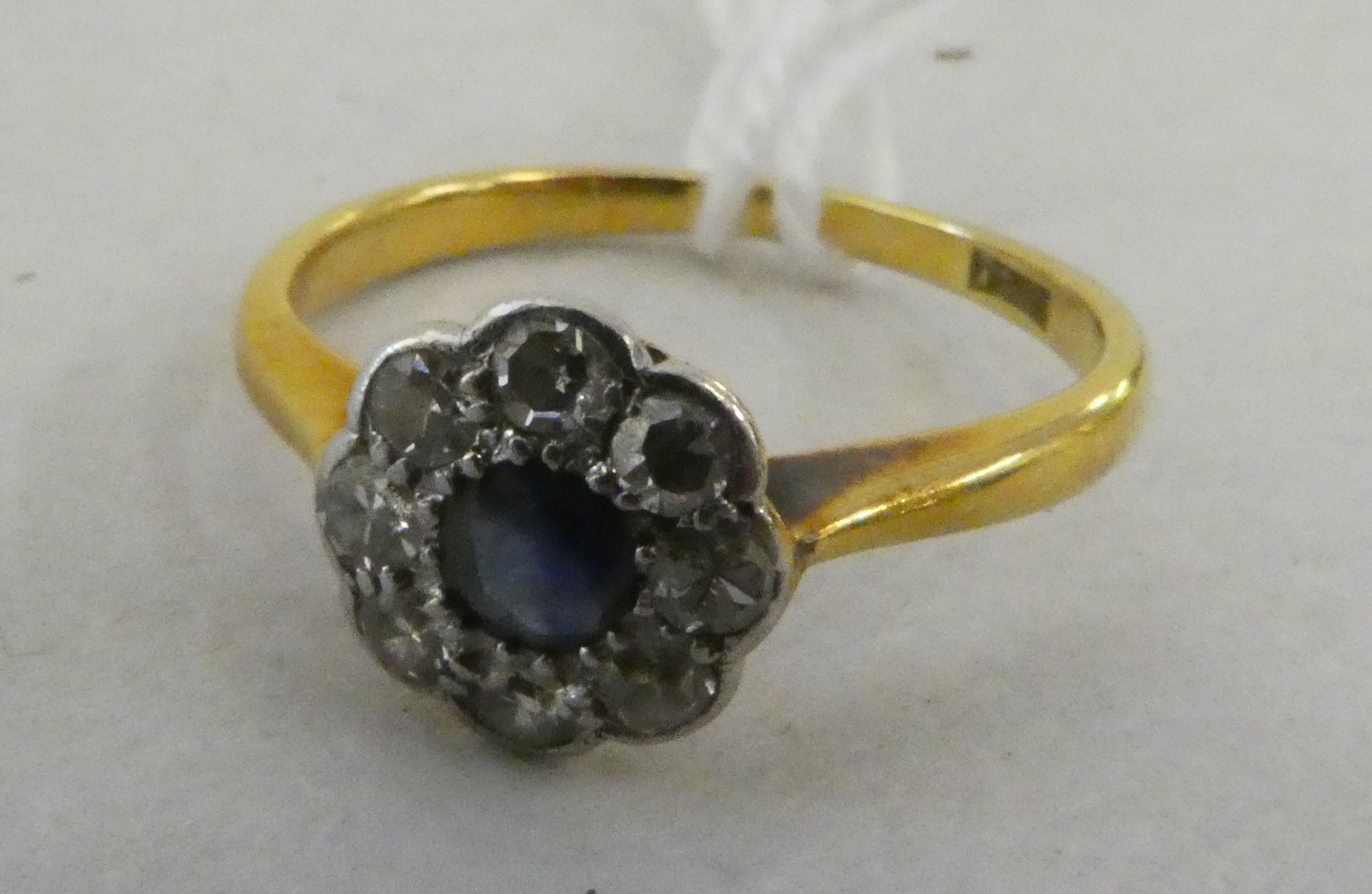 An 18ct gold diamond and sapphire cluster ring