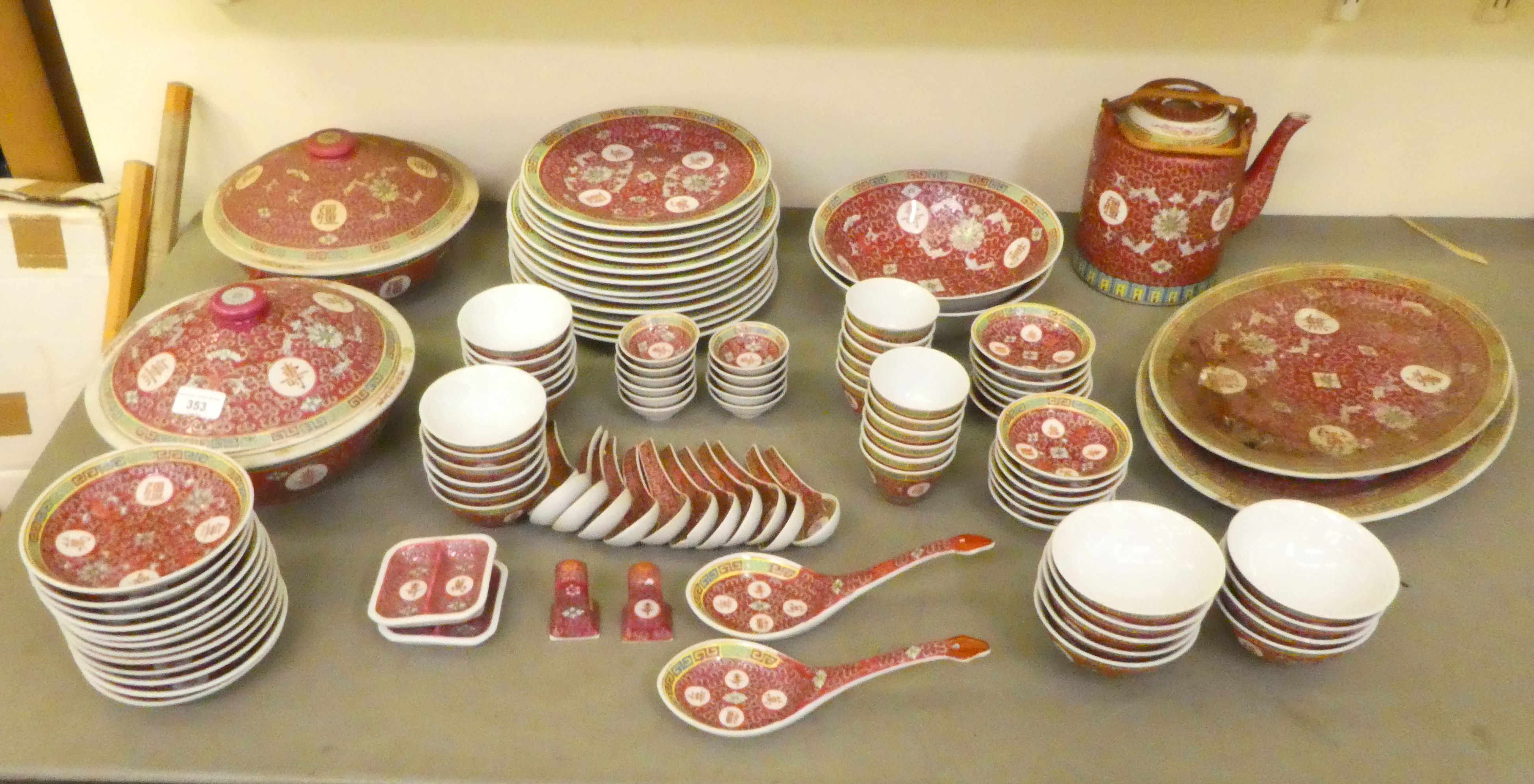 A mid 20thC Chinese porcelain dinner service, decorated with maroon flora and characters