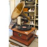 A modern reproduction of an early 20thC gramophone with a gilded, pressed metal horn, on a square