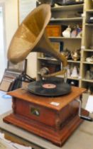 A modern reproduction of an early 20thC gramophone with a gilded, pressed metal horn, on a square