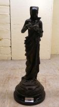 A patinated spelter figure, after Carrier Belleuse, a woman reading a book  17"h