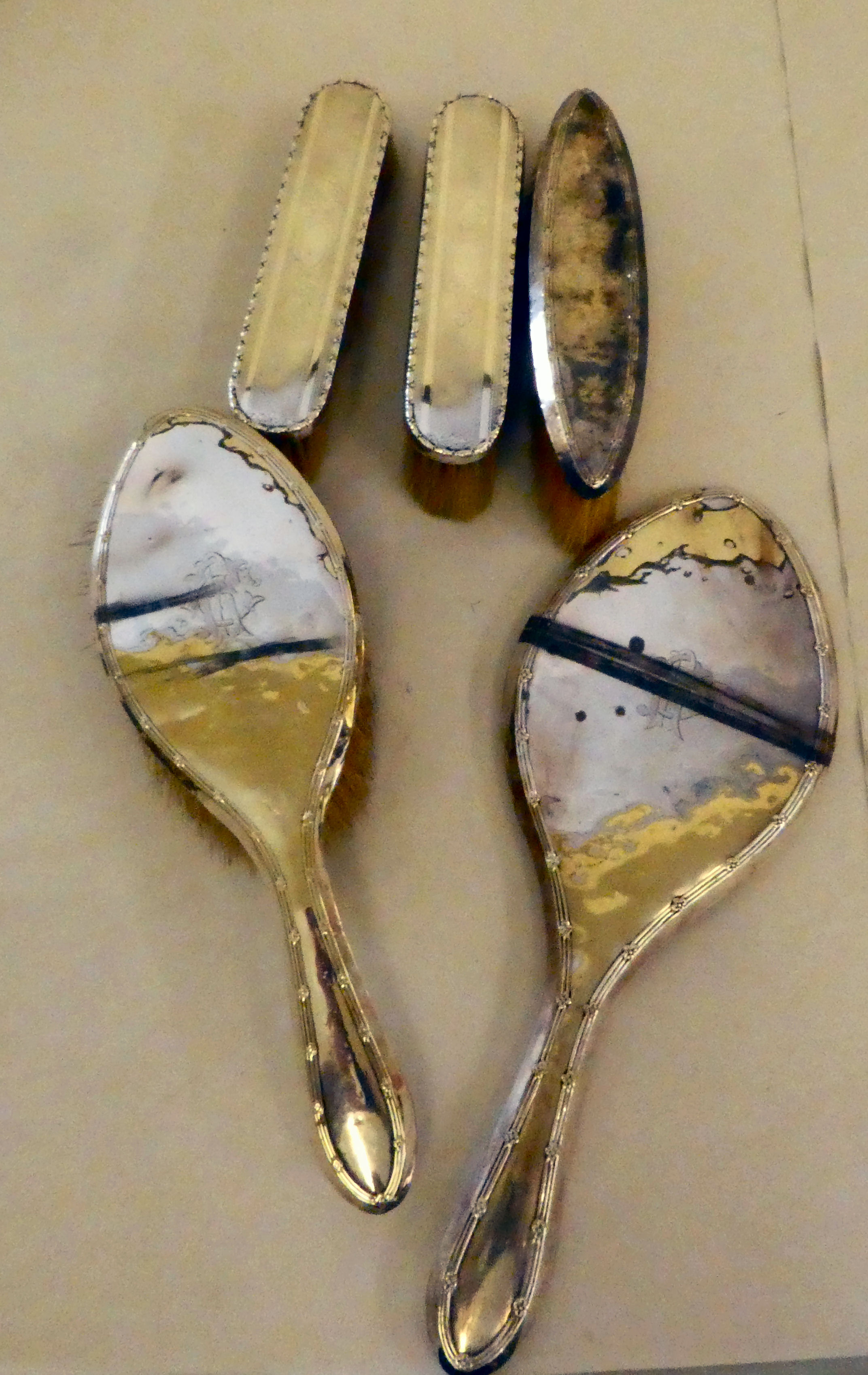 Silver backed dressing table accessories: to include a hand mirror  mixed marks