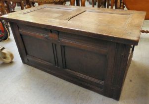 An 18thC twin panelled oak chest with straight sides and a rising top, on iron wire hinged  16"h